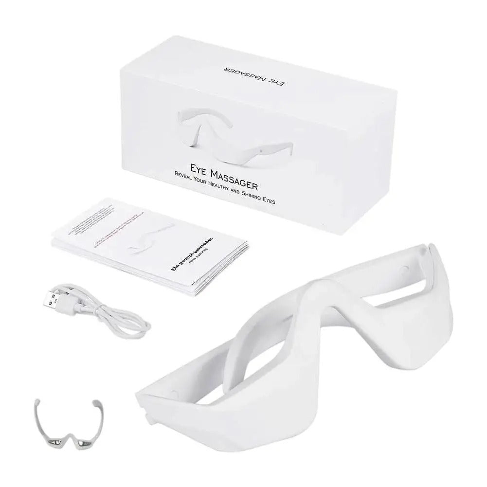White eye massager with packaging, USB cable, and user manual on a white background
